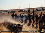 Barbaric: Around 20 Islamic State fighters stand behind the line of men and the squad of jihadists begin to gun down the prisoners