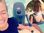 Loving life out at sea! Model Lara Bingle looks on top of the world as she steers a motorised boat after freezing on a beach photoshoot