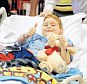 Nine-year-old James Barney, Jr., gives a thumbs-up as he is wheeled out of aa news conference at Arnold Palmer Hospital in Orlando, Fla., where he talked about his dramatic encounter with an alligator while swimming in a lake earlier this week, on Friday, Aug. 8, 2014