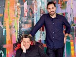 Behind the scenes! Designer Isaac Mizrahi (seated) and his husband Arnold Germer in their den. The painting behind them is by Tomory Dodge