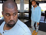 Why so glum? Kanye West looks downcast as he arrives at LAX wearing ripped jeans
