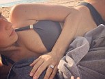Taking it easy: Hilaria Baldwin lounges on a beach in her bikini while breastfeeding her daughter in an Instagram snap posted Tuesday