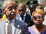 'Be a man': Seen here with Rev. Al Sharpton on Tuesday, Michael Brown's grieving mother Lesley McSpadden has sent out a plea to the unnamed Missouri police officer who shot her son Saturday