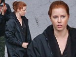 The great cover up! Amy Adams keeps dry with a raincoat as she heads to the gloomy Detroit set of Batman V Superman to reprise her role of Lois Lane