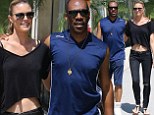 Eddie Murphy cosies up to model girlfriend Paige Butcher as she shows off her toned midriff during romantic stroll