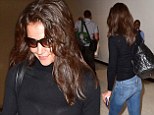 Barefaced Katie Holmes is a casual flyer in fitted jeans and trainers as she jets out of LAX
