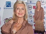 Olivia Newton-John sports a leopard print skirt and sophisticated satin blouse at Four Star Awards in Vegas