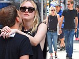 Dakota Fanning wraps her arms around her dress-a-like boyfriend Jamie Strachan while shopping in NYC