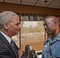 Meeting: Attorney General Eric Holder speaks with Capt. Ron Johnson of the Missouri State Highway Patrol at Drake's Place Restaurant, on Wednesday