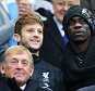 Liverpool's Adam Lallana (left) and Mario Balotelli in the stands during the Barclays Premier League match at the Etihad Stadium, Manchester. PRESS ASSOCIATION Photo. Picture date: Monday August 25, 2014. See PA story SOCCER Man City. Photo credit should read: Peter Byrne/PA Wire. RESTRICTIONS: Editorial use only. Maximum 45 images during a match. No video emulation or promotion as 'live'. No use in games, competitions, merchandise, betting or single club/player services. No use with unofficial audio, video, data, fixtures or club/league logos.