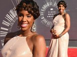 Kelly Rowland is awaiting the arrival of her first child, a son, with husband and manager Tim Witherspoon. For now, the 33-year-old is enjoying her pregnancy as seen while walking the red carpet at the 2014 MTV VMAs on Sunday night. As she arrived to the awards show the former Destiny's Child singer protectively held her growing baby bump which she showcased in a beautiful pink sequin-covered gown.