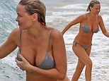 Lara's boob bungle: Bingle grapples with her bikini and nearly exposes her modesty as she hits the surf with Sam Worthington