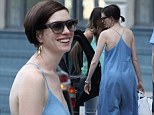 Breezy in blue: Anne Hathaway concealed her lean physique with a baggy denim jumpsuit as she stepped out with friends in New York City Saturday