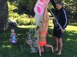 'Carmen lent us her bathtub': Bikini-clad Hilaria Baldwin does the ALS Ice Bucket Challenge while doing a handstand