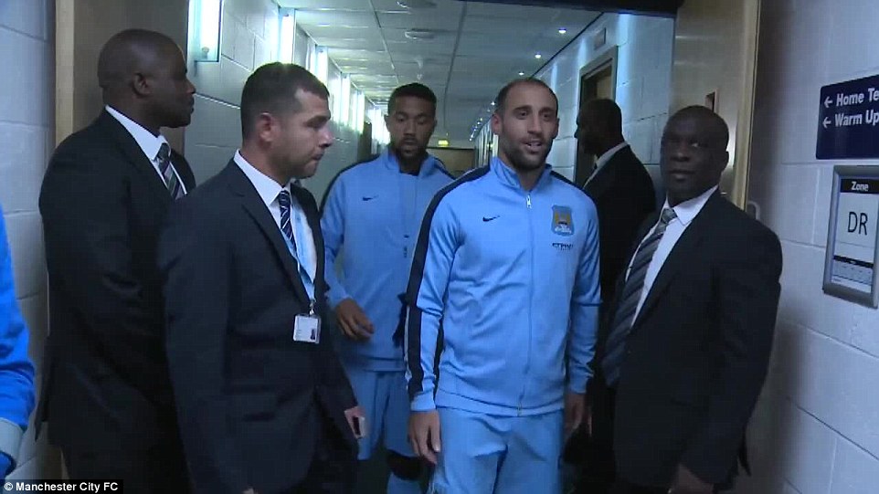 Sight for sore eyes: Zabaleta (centre) looked happy to see former team-mate Balotelli in the tunnel before the match
