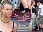 The couple who coordinates... Behati Prinsloo and her husband Adam Levine sported matching burgundy Dr. Martens boots as they shopped around New York's Soho neighbourhood on Tuesday