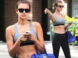 All hail Irina! Stunning Sport Illustrated starlet Shyak flags down NYC cab as she bares her toned midriff in sports bra
