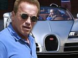 2744550 He'll be back! Arnold Schwarzenegger looks as cool as they come as he hops into sports car after visiting his office in Los Angeles