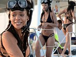 Ahoy there! Rihanna shows off her flawless figure in a tiny halter-neck bikini during a snorkelling trip with friends in Barbados