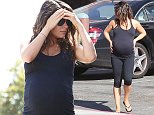 Pregnant Mila Kunis clutches her growing belly before attending her yoga class in Studio City. September 18, 2014 \nEXCLUSIVE\nOK FOR WEB SITE USAGE.\nAny quieries please call Alasdair or Gary on office 0034 966 713 949/926 or mibile Gary 0034 686 421 720 or Alasdair on 0034 630 576 519