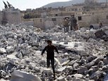 Residents inspect damaged buildings in what activists say was a U.S. strike, in Kfredrian, Idlib province&nbsp;