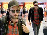 UK CLIENTS MUST CREDIT: AKM-GSI ONLY\nEXCLUSIVE: Los Angeles, CA - Robert Pattinson arrives at LAX airport for his flight and seems to be in a good mood.  After all the time his has been spending with new girlfriend FKA Twigs, whats not to be happy about.  Robert walks through the terminal dressed casually in sunglasses, a black jacket over a red plaid shirt with dark gray jeans.\n\nPictured: Robert Pattinson\nRef: SPL857198  031014   EXCLUSIVE\nPicture by: AKM-GSI / Splash News\n\n