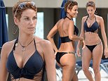 EXCLUSIVE TO INF.\nOctober 20, 2014: Nicole Murphy, mother of four, ex wife of Eddie Murphy, and ex partner of Michael Strahan - Strahan is an ex Giants football player and host of morning show 'Kelly And Michael' - shows off her curves in a black lace up bikini while enjoying some time on Miami Beach, Florida with friends.\nMandatory Credit: INFphoto.com Ref: infusmi-13|sp|CODE000