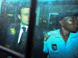 epa04455911 Members of the South African Police Service with Oscar Pistorius (L) in the back of an armoured police vehicle as he is transported away from the High Court  in Pretoria, South Africa 21 October 2014. Oscar Pistorius was sentenced to 5 years in prison after being convicted of culpable homicide for his part in the shooting of his model girlfriend Reeva Steenkamp in February 2013.  EPA/KEVIN SUTHERLAND