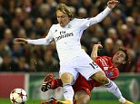 Joe Allen of Liverpool tackles Luka Modric of Real Madrid