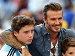 Former England international David Beckham and sons Brooklyn Beckham (L), Cruz Beckham (2nd R) and Romeo Beckham (R) prior to the 2014 FIFA World Cup Brazil Final match between Germany and Argentina at Maracana on July 13, 2014 in Rio de Janeiro, Brazil.  (Photo by Michael Steele/Getty Images)