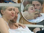 Miley Cyrus and Patrick Schwarzenegger kiss and cuddle at a restaurant on vacation in Miami. \n\nRef: SPL905570  051214  \nPicture by: Splash News\n\nSplash News and Pictures\nLos Angeles: 310-821-2666\nNew York: 212-619-2666\nLondon: 870-934-2666\nphotodesk@splashnews.com\n