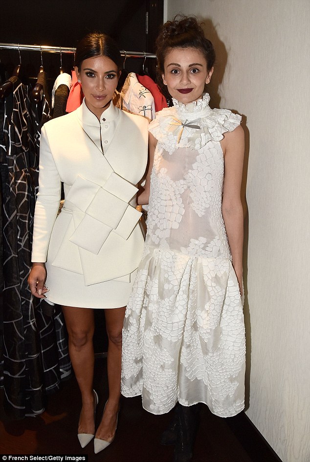 All white: Kim posed with Natalia Alaverdan who designed the origami style dress she was wearing that evening