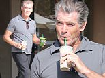 Please contact X17 before any use of these exclusive photos - x17@x17agency.com   Pierce Brosnan shows muscles while enjoying a smoothie and talking to some fans. The actor is looking really well for being 61 walking around Malibu in a tight shirt.  January 21, 2015 X17online.com