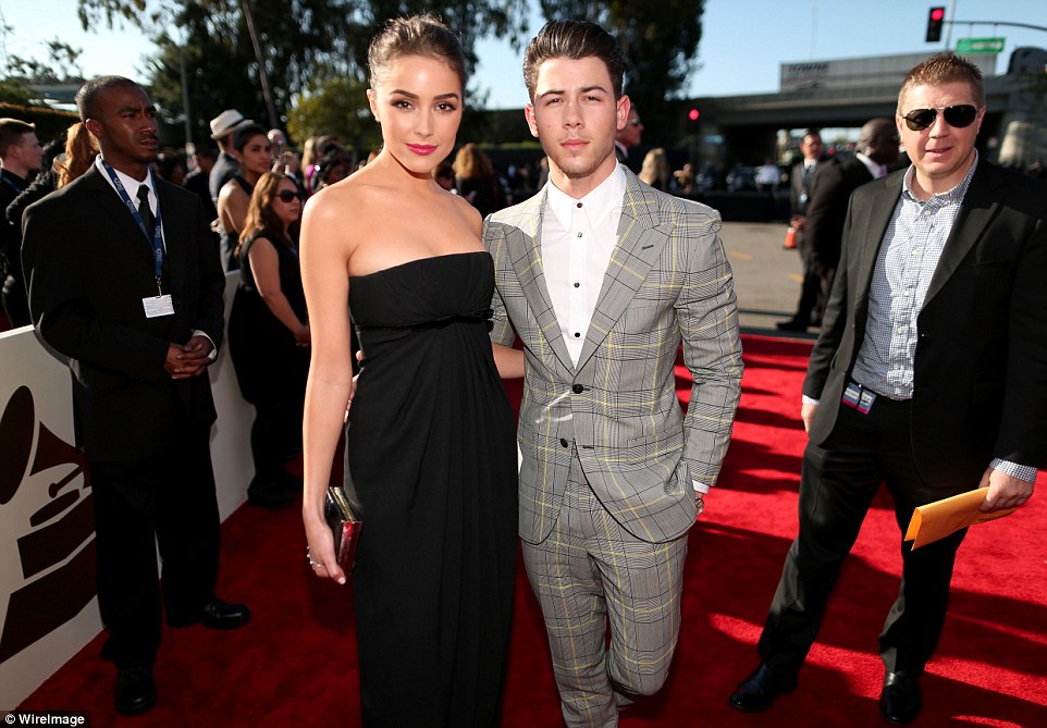 His girl pulled it off: Nick Jonas wore a plaid suit in grey and yellow with blue but his better half Olivia Culpo looked stunning in a strapless black silk number and no jewelry