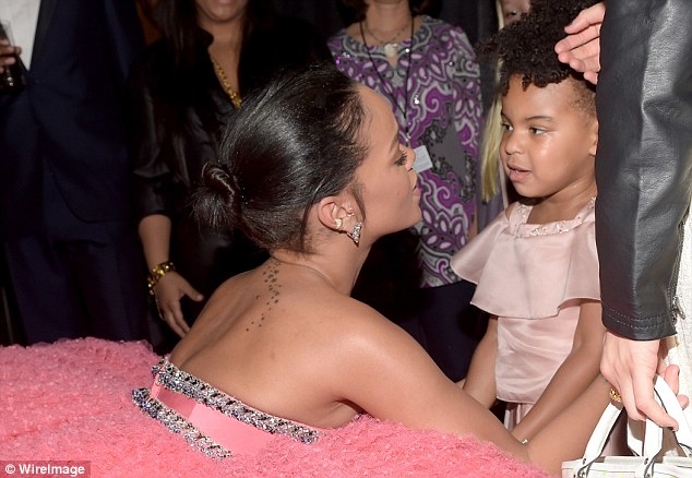 Tender moment: Rihanna greets her pal Beyonce's three-year-old daughter Blue Ivy at the Grammys