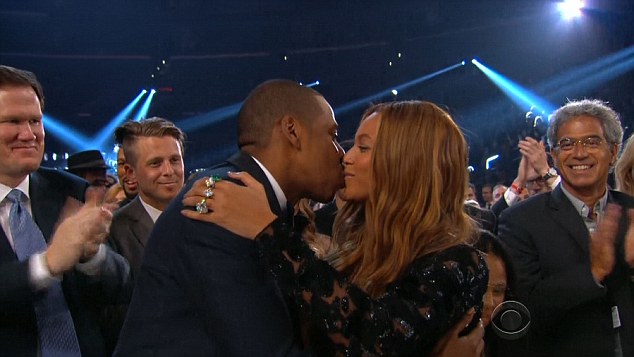 Sealed with a kiss: The pair locked lips before Beyonce took to the stage alone 