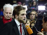 British actor Robert Pattinson answers journalists upon arrival for the screening of the film "Life" presented as Berlinale Special at the 65th Berlin International Film Festival Berlinale  in Berlin, on February 9, 2015. AFP PHOTO / JOHN MACDOUGALLJOHN MACDOUGALL/AFP/Getty Images