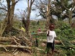 Children inspect the debris while residents deal with the damage to their homes in Seaside, near the Vanuatu capital of Port Vila ©Chris McCowage (Australian Red Cross/AFP)