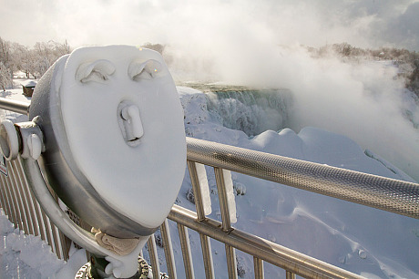 A face appears on some icy scenic lookout binoculars