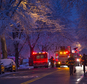 Firefighters walk near the scene of a fire, center left, in which seven children died in the Brooklyn borough of New York Saturday, March 21, 2015. (AP Photo/Craig Ruttle)