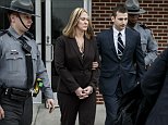 Hummelstown police officer Lisa J. Mearkle is escorted from District Judge Lowell Witmer's office, in West Hanover Township, Pa., after her preliminary arraignment, Tuesday, March 24, 2015, in the fatal shooting of David A. Kassick last month in South Hanover Township. Mearkle was charged Tuesday with criminal homicide after investigators concluded she shot the unarmed motorist in the back as he lay facedown after a traffic stop over an expired inspection sticker. (AP Photo/PennLive.com, Dan Gleiter)