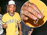 Wiz Khalifa lights up a funny looking, hand-rolled cigarette on the streets of Hollywood as he arrives at Project Club to support Mike B's party. March 23, 2015 X17online.com