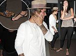 Picture Shows: Justin Bieber  March 27, 2015
 
 Freshly roasted pop star Justin Bieber enjoys a night out on the town in Los Angeles, California. The Biebs is always finding ways to show his fans how much he loves them and tonight was no exception. Justin graciously (and perhaps accidentally, jury's out on that) stepped on the bare foot of a female smoker out front of an establishment. While the moment may have been painful, she can at least take solace in the fact she'll always have the story to tell of "that one night in LA when Justin Bieber like totally stepped on my foot, you guys! I can't even!".
 
 Non-Exclusive
 UK Rights Only
 
 Pictures by : FameFlynet UK    2015
 Tel : +44 (0)20 3551 5049
 Email : info@fameflynet.uk.com
