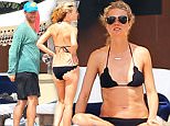 NO WEB USE - Actress Gwyneth Paltrow and her estranged husband Chris Martin look very comfortable together as they enjoy a beach vacation with their kids Apple and Moses in Puerto Vallarta, Mexico from March 27 through 31, 2015. The pair was were both without their wedding rings but they looked happy relaxing, laughing and doting on their children. Chris took the kids out in a boat to do some tubing while Gwyneth relaxed on the beach. After their boat ride Chris watched the kids snorkel near the shore before hanging out with Gwyneth. NO WEB USE\\n