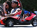 **USA ONLY** *EXCLUSIVE* Woodland Hills, CA - Kylie Jenner tries to cover her face while joy riding with rumored boyfriend Tyga in his Slingshot 3 wheel Motorcycle.  All though the two fail to speak and reveal too much about their relationship, they both look very comfortable with each other to label them as a couple.  The Slingshot Motorcycle is a fast machine and both Tyga and Kylie decided to ride without helmets.  What would momager Kris Jenner say?\\n\\nAKM-GSI        April 2, 2015\\n\\n**MANDATORY CREDIT MUST READ: FameFlynet/AKM-GSI**\\n\\nTo License These Photos, Please Contact :\\n \\n Steve Ginsburg\\n (310) 505-8447\\n (323) 423-9397\\n steve@akmgsi.com\\n sales@akmgsi.com\\n \\n or\\n \\n Maria Buda\\n (917) 242-1505\\n mbuda@akmgsi.com\\n ginsburgspalyinc@gmail.com