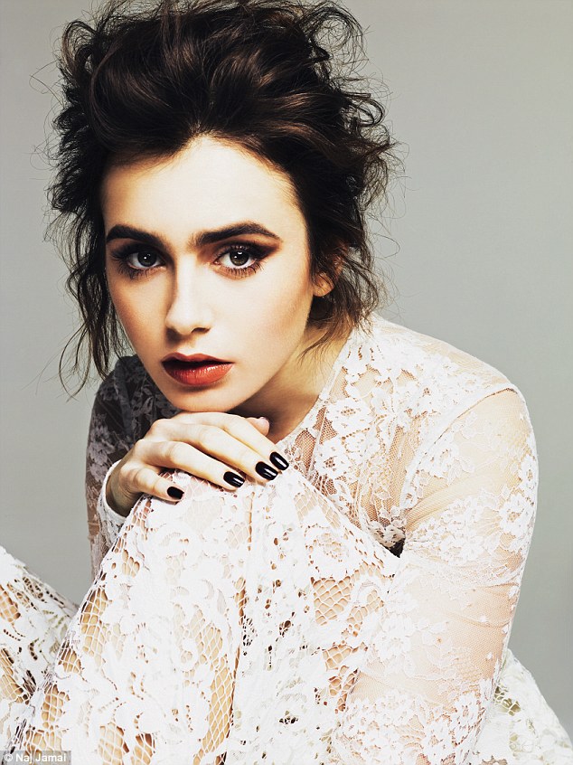 Gothic style: Posing in a sheer lace dress, Lily is seen with messy bed head hair, modelling a glossy red lip and vampy black nails in the May issue of Glamour magazine