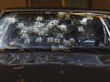 FILE - In this Nov. 30, 2012 file forensics photo released by the Office of the Ohio Attorney General, bullet holes are visible on the windshield and hood of a Chevy Malibu peppered by gunshots after a high-speed chase that ended in the deaths of two unarmed suspects. Patrolman Michael Brelo faces two voluntary manslaughter charges in the shooting deaths of Timothy Russell and Malissa Williams. His trial is scheduled to begin Monday, April 6, 2015 in Cleveland. (AP Photo/Office of the Ohio Attorney General, File)