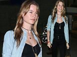 Behati Prinsloo, wife of Adam Levine catching a flight at LAX in basic black and dressed down April 6, 2015  X17online.com