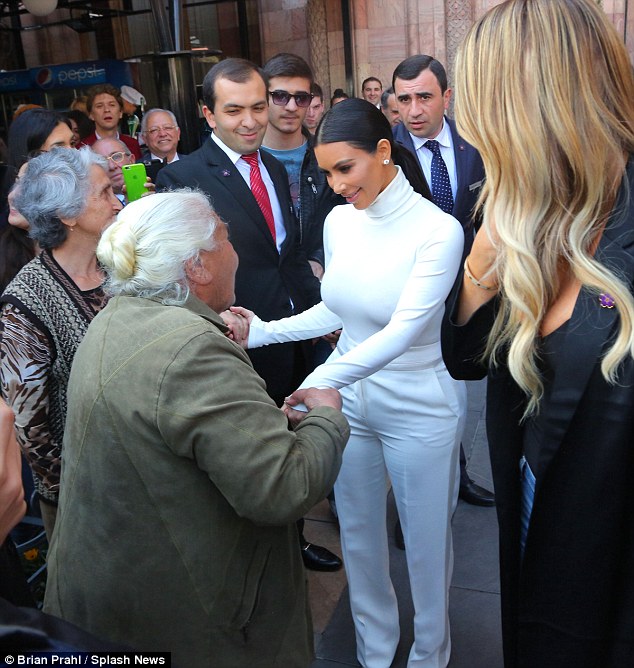 Honoured: The woman earnestly held Kim's hand while speaking to her