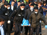 In this April 9, 2015 photo, South Korean police officers carry the body of Sung Wan-jong in Seoul, South Korea. South Korean President Park Geun-hye faced c...